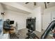 Bright office area featuring wood-look desk and storage cubbies, alongside home gym equipment at 5188 Ward Rd, Wheat Ridge, CO 80033