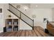 Staircase with hardwood floors, storage shelves, and modern decor at 5188 Ward Rd, Wheat Ridge, CO 80033