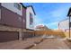 View of modern townhouses with attached garages, adjacent to a gas station at 5188 Ward Rd, Wheat Ridge, CO 80033