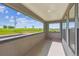 A covered balcony with a scenic view of an open green field under a partly cloudy, bright blue sky at 11493 E Briarwood Cir, Centennial, CO 80112