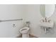 Half bath features a modern toilet and sink, with accessibility support at 11493 E Briarwood Cir, Centennial, CO 80112
