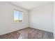 Bright, carpeted bedroom with a large window offering neighborhood views and neutral wall color at 11493 E Briarwood Cir, Centennial, CO 80112