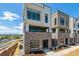 Modern townhome featuring a brick facade, balcony, and large windows providing ample natural light at 11493 E Briarwood Cir, Centennial, CO 80112
