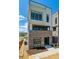 Stylish three-story townhome boasting a brick base, modern design, and an inviting entrance at 11493 E Briarwood Cir, Centennial, CO 80112