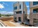 Contemporary townhome with brick accents, a walk-up entrance, and views of the surrounding landscape at 11493 E Briarwood Cir, Centennial, CO 80112