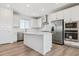 Bright, open kitchen with white cabinets, stainless appliances, and a center island, hard surface flooring at 11493 E Briarwood Cir, Centennial, CO 80112