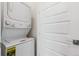 Convenient laundry area with stacked washer and dryer and ample storage space at 11493 E Briarwood Cir, Centennial, CO 80112