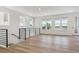 Spacious and bright living area featuring modern railings, hardwood floors, and large windows at 11493 E Briarwood Cir, Centennial, CO 80112