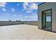 A spacious rooftop deck with tile flooring and stunning sky views, ideal for entertaining at 11493 E Briarwood Cir, Centennial, CO 80112