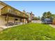 Large, grassy backyard features a patio, a second-story deck and backyard play equipment at 2104 Vineyard Dr, Castle Rock, CO 80104