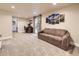 Finished basement featuring a comfortable lounge area, workspace, and sliding glass door at 2104 Vineyard Dr, Castle Rock, CO 80104