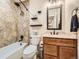 Modern bathroom with shower-tub combo, granite countertops, and stylish mirror with vanity lighting at 2104 Vineyard Dr, Castle Rock, CO 80104