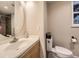 Bathroom features a vanity with a sink and mirror, along with a toilet at 2104 Vineyard Dr, Castle Rock, CO 80104