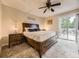 Comfortable bedroom with wooden furniture, ceiling fan, and sliding glass door opening to a private balcony at 2104 Vineyard Dr, Castle Rock, CO 80104