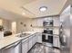 Bright kitchen with stainless steel appliances, sleek countertops, and open layout to the living area at 2104 Vineyard Dr, Castle Rock, CO 80104
