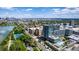 Aerial view of the condo building with a lake, tennis court, and city skyline in the background at 4200 W 17Th Ave # 212, Denver, CO 80204