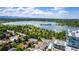Aerial view of a lake with green landscape, single Gathering houses and a modern condo building at 4200 W 17Th Ave # 212, Denver, CO 80204