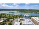 Aerial view of a modern condo building with a lake and lush green landscape at 4200 W 17Th Ave # 212, Denver, CO 80204