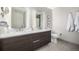 Modern bathroom with double sinks, a large mirror, and gray tile flooring, offering a spa-like experience at 4200 W 17Th Ave # 212, Denver, CO 80204