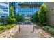 A sleek, modern building entrance is showcased with glass facade, well-maintained landscaping, and inviting walkway at 4200 W 17Th Ave # 212, Denver, CO 80204