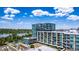 Exterior view of a glass condo building with a rooftop pool and lake at 4200 W 17Th Ave # 212, Denver, CO 80204