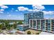 Exterior view of a glass condo building with a rooftop pool and a lake in the background at 4200 W 17Th Ave # 212, Denver, CO 80204