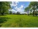 Expansive green space with lush grass, trees, and a bright, sunny sky with scattered clouds at 4200 W 17Th Ave # 212, Denver, CO 80204