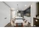 Open kitchen boasts stainless steel appliances, center island, and modern lighting at 4200 W 17Th Ave # 212, Denver, CO 80204