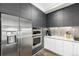 Modern kitchen features stainless steel refrigerator, built-in oven and microwave, and sleek gray cabinets at 4200 W 17Th Ave # 212, Denver, CO 80204