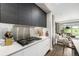 Sleek kitchen with stainless steel backsplash, gray cabinets and white countertops in a modern design at 4200 W 17Th Ave # 212, Denver, CO 80204