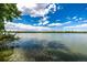 Beautiful lake view featuring calm water, clear skies, and lush shoreline vegetation at 4200 W 17Th Ave # 212, Denver, CO 80204