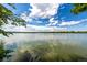 This scenic water view captures the beauty of a peaceful lake under a vast, partly cloudy sky at 4200 W 17Th Ave # 212, Denver, CO 80204