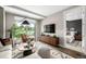 Bright living room leads into a bedroom and features a modern entertainment center and outdoor views at 4200 W 17Th Ave # 212, Denver, CO 80204