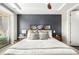 Serene main bedroom with a large window, tray ceilings, and neutral decor with a pop of black paint at 4200 W 17Th Ave # 212, Denver, CO 80204