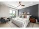 Relaxing main bedroom with gray accent wall, ceiling fan, and lots of natural light at 4200 W 17Th Ave # 212, Denver, CO 80204