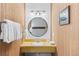 Small bathroom with a round mirror and yellow vanity at 1140 Ski Hill Rd # 25, Breckenridge, CO 80424