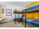 Bedroom with built-in bunk beds and yellow accent wall at 1140 Ski Hill Rd # 25, Breckenridge, CO 80424