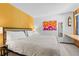 Bright bedroom with a king-size bed and mustard yellow walls at 1140 Ski Hill Rd # 25, Breckenridge, CO 80424