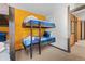 Bedroom with built-in bunk beds and yellow accent wall at 1140 Ski Hill Rd # 25, Breckenridge, CO 80424