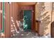 Condo building entry with green door and wood siding at 1140 Ski Hill Rd # 25, Breckenridge, CO 80424