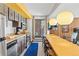 Long breakfast bar with seating, stainless steel appliances and wood cabinets at 1140 Ski Hill Rd # 25, Breckenridge, CO 80424