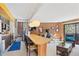 Spacious living room with a long breakfast bar and a cozy area with balcony access at 1140 Ski Hill Rd # 25, Breckenridge, CO 80424