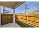 Backyard patio with wood fence and partial view of neighborhood homes at 7453 E 26Th Ave # 2, Denver, CO 80238