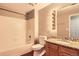 Bathroom features shower over tub, tiled walls, and vanity with granite countertops at 7453 E 26Th Ave # 2, Denver, CO 80238