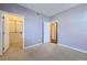 Bedroom featuring neutral walls and carpet. Walk-in closet can be seen through open door at 7453 E 26Th Ave # 2, Denver, CO 80238