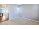 Bedroom featuring neutral walls and carpet. Hardwood flooring can be seen through doorway at 7453 E 26Th Ave # 2, Denver, CO 80238