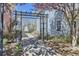 Landscaped community entrance with flowering trees, signage and paver walkway at 7453 E 26Th Ave # 2, Denver, CO 80238