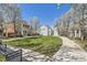 Green community with various home styles and a walkway for residents at 7453 E 26Th Ave # 2, Denver, CO 80238