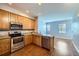 Bright kitchen with stainless steel appliances, granite counters, and an open layout to living room at 7453 E 26Th Ave # 2, Denver, CO 80238