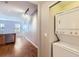 Laundry area featuring a stacked washer and dryer, with an open view to the kitchen at 7453 E 26Th Ave # 2, Denver, CO 80238